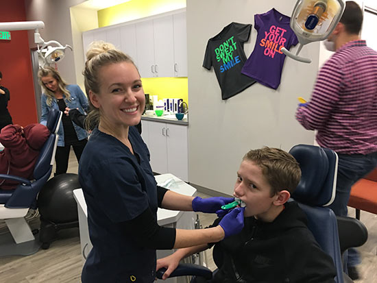 Happy team member with boy patient